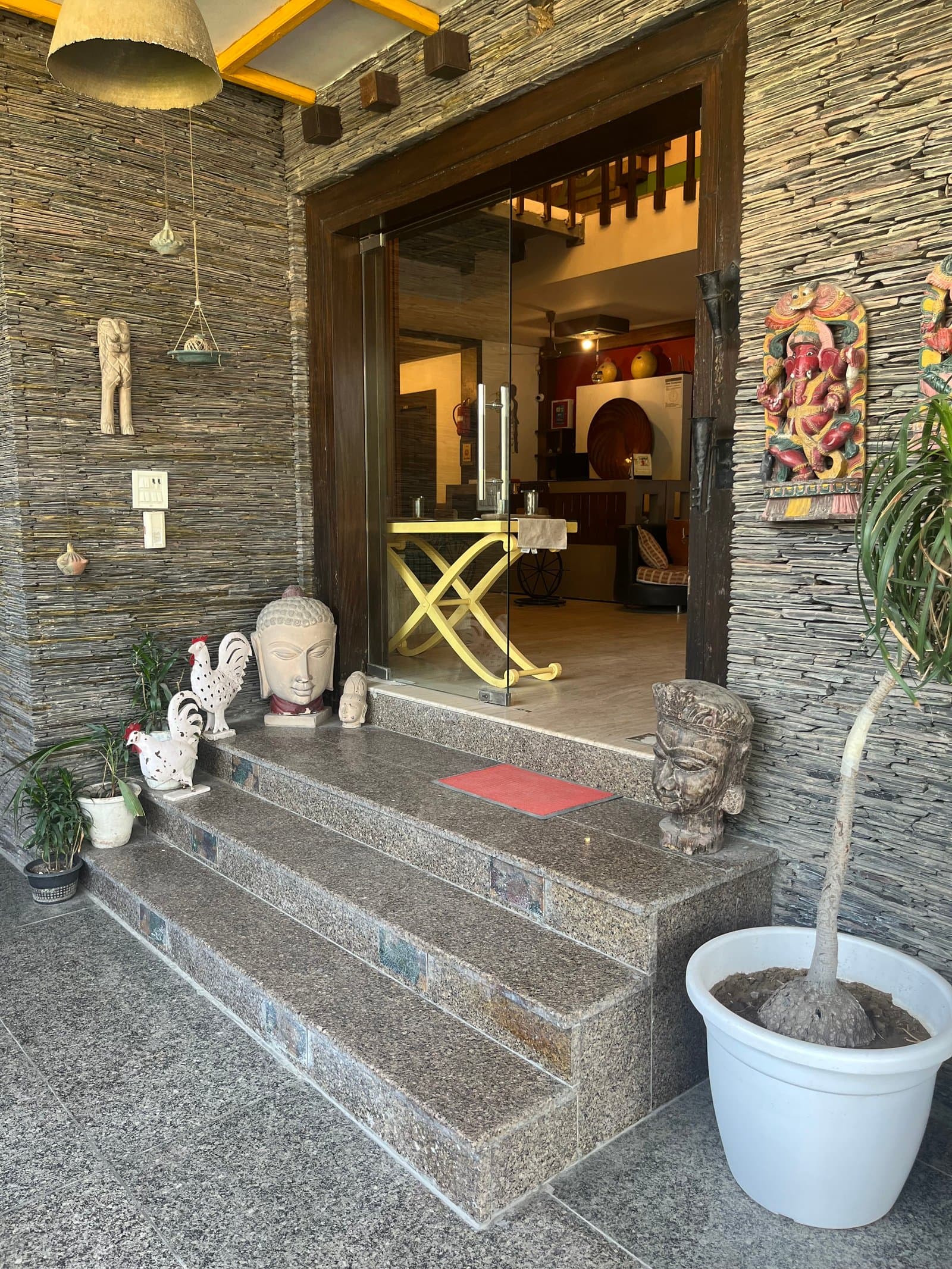 The stone-clad entrance at Aakriti Hotels, Sector 23 Gurugram