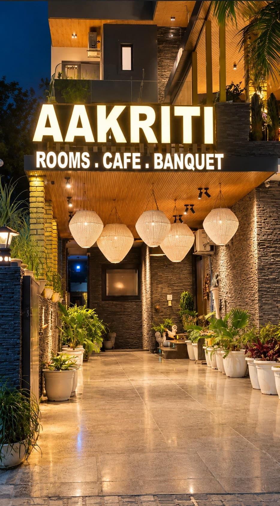 The entrance porch at Aakriti Hotels lit at night, Sector 23 Gurugram