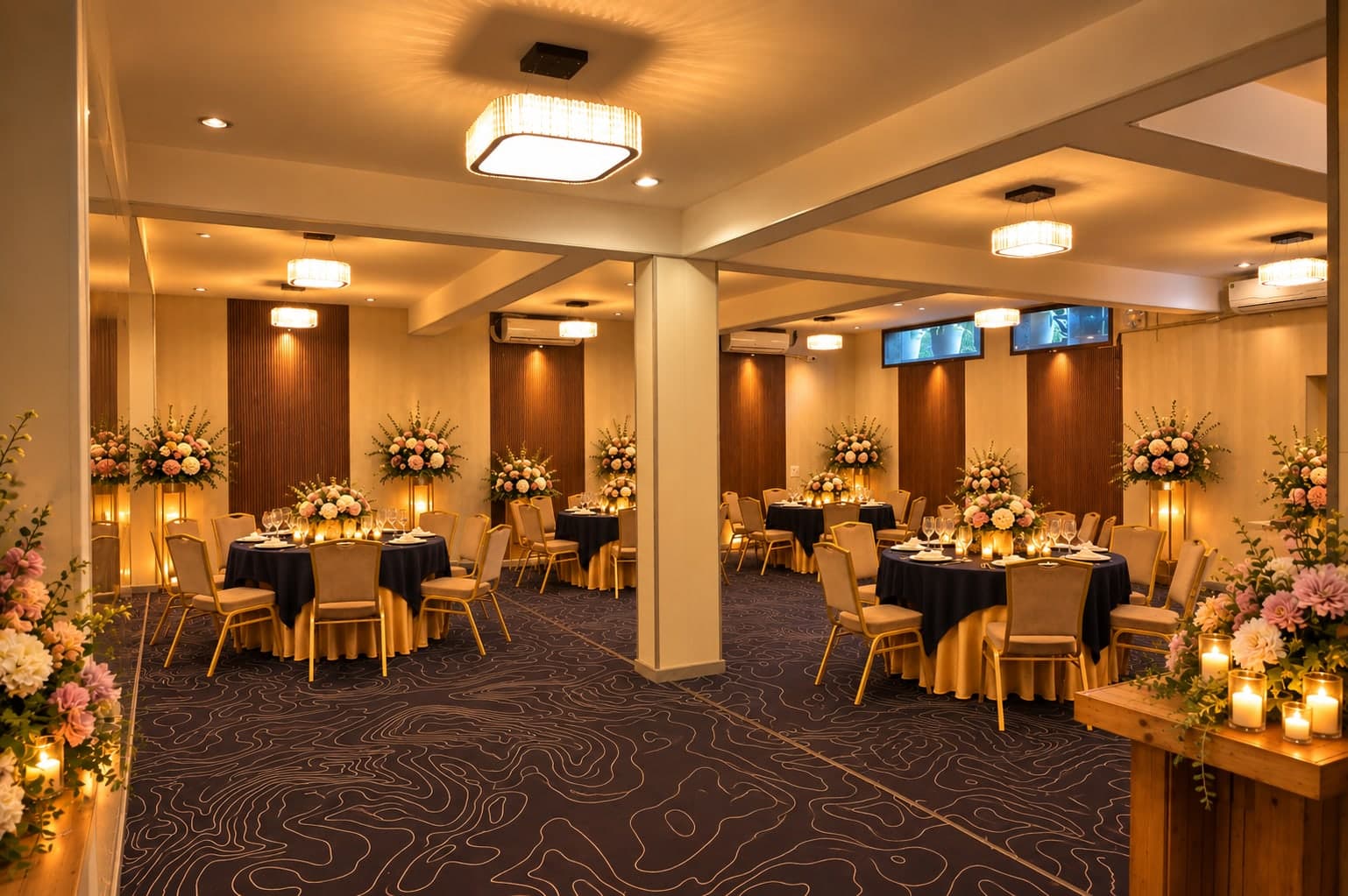 The banquet hall laid for dinner at Aakriti Hotels