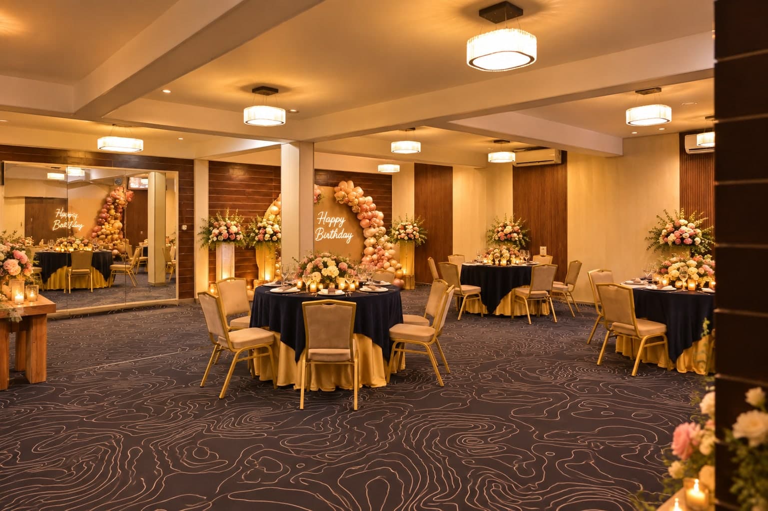 Stage and floral decor in the banquet hall at Aakriti Hotels
