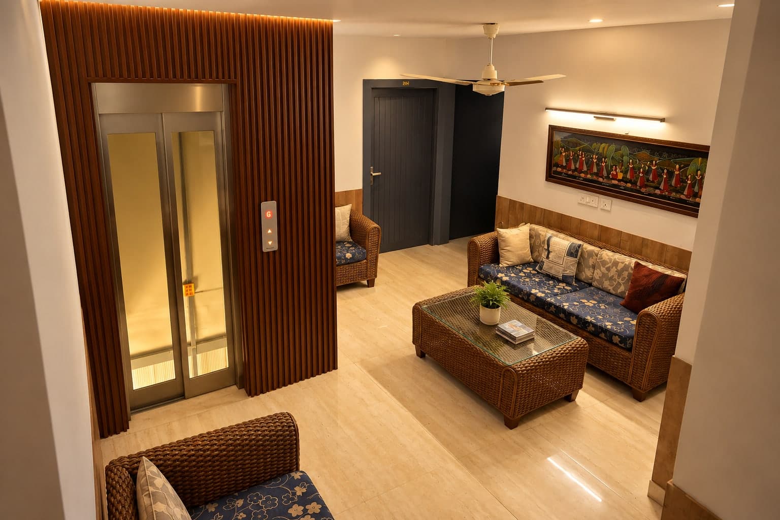 Lift lobby with wicker seating at Aakriti Hotels