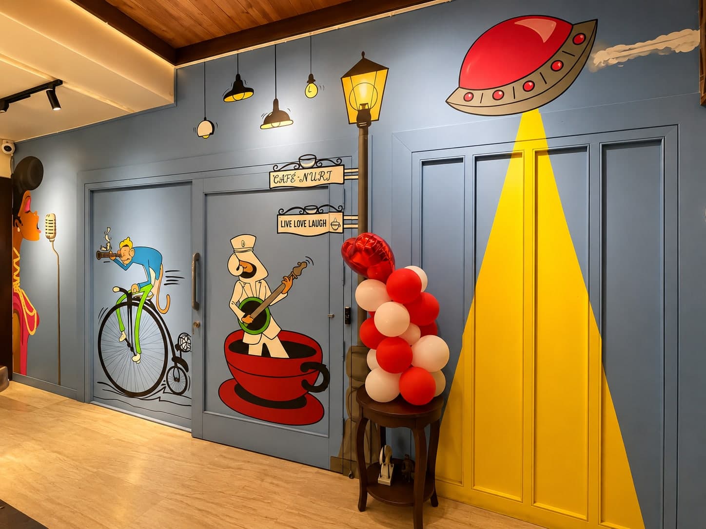The painted mural wall at the entrance of Aakriti Hotels